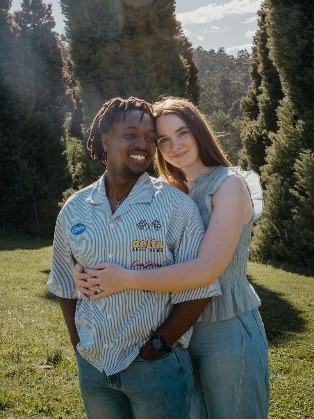 Amelia and Quinton smiling together in a sunlit garden