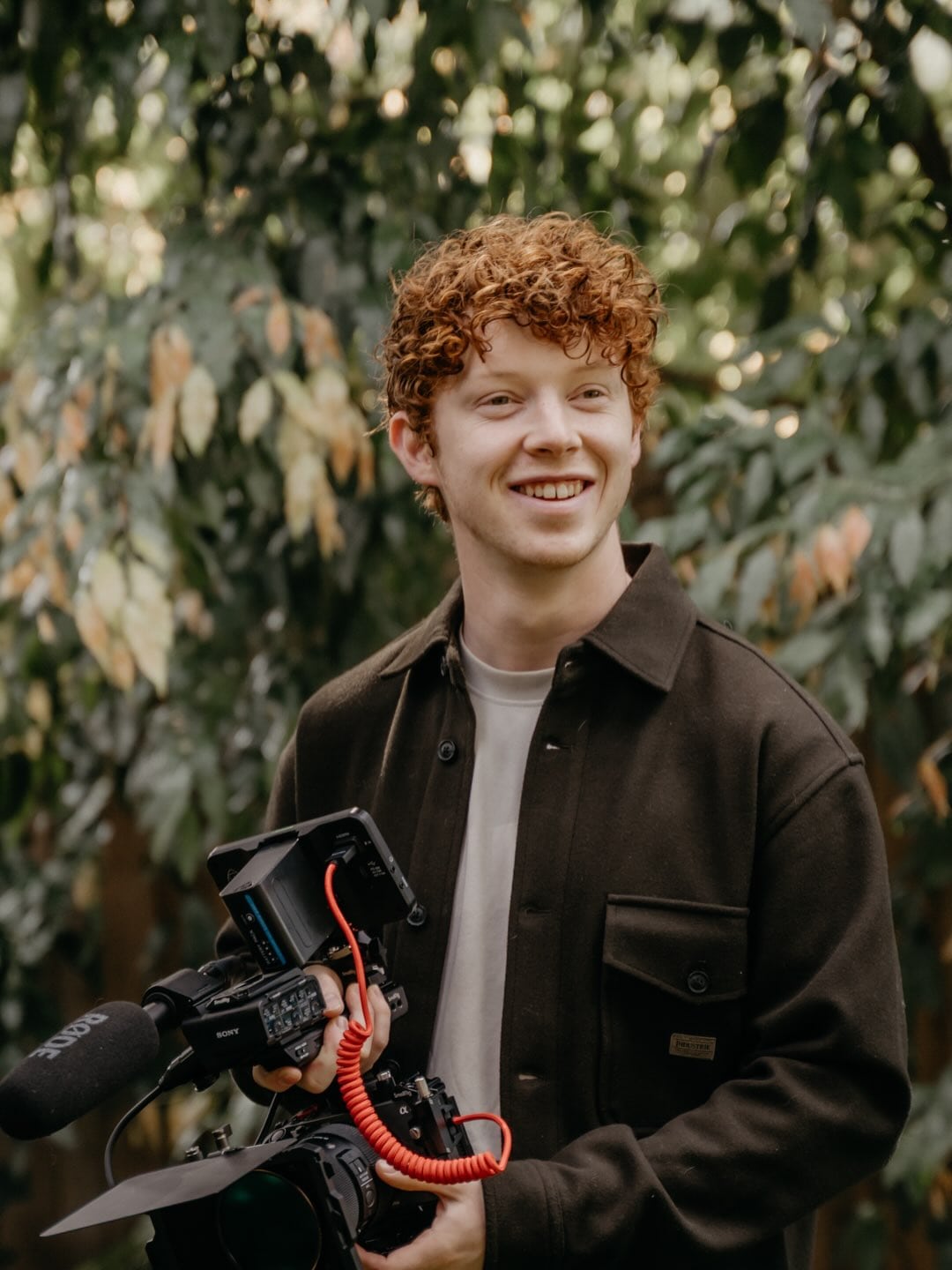 Ben holding his video camera outdoors