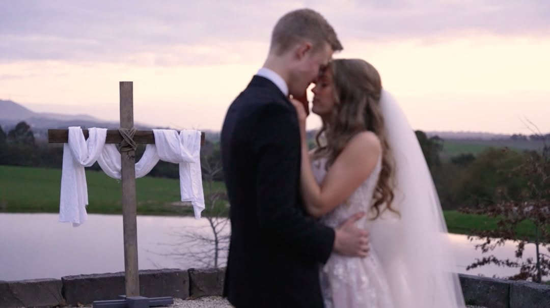 Wedding film still of the newly married couple at sunset